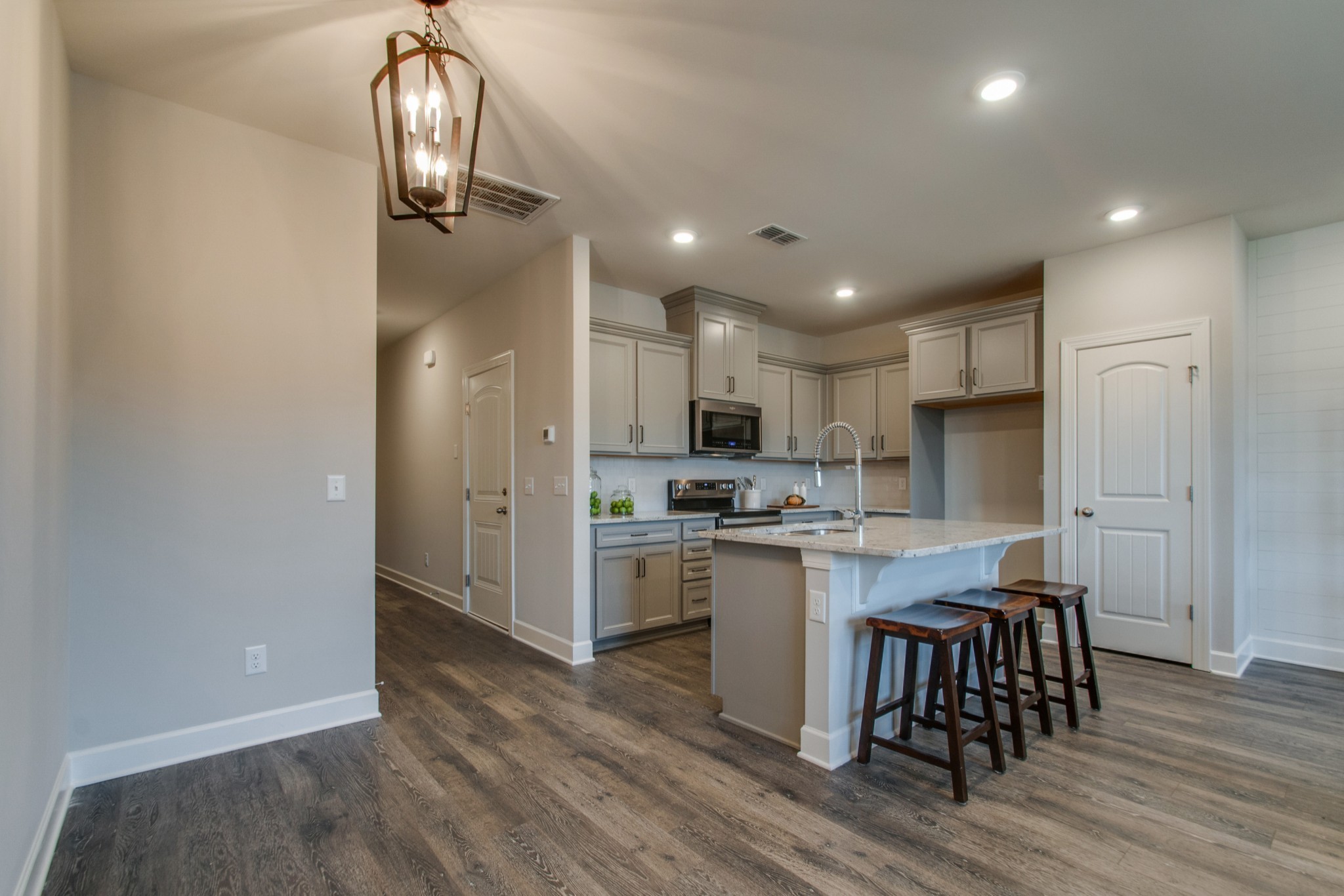 3309 Deerchase Circle Murfreesboro, TN 37129 - Photo 6 of 27 a kitchen with kitchen island granite countertop a sink cabinets and wooden floor