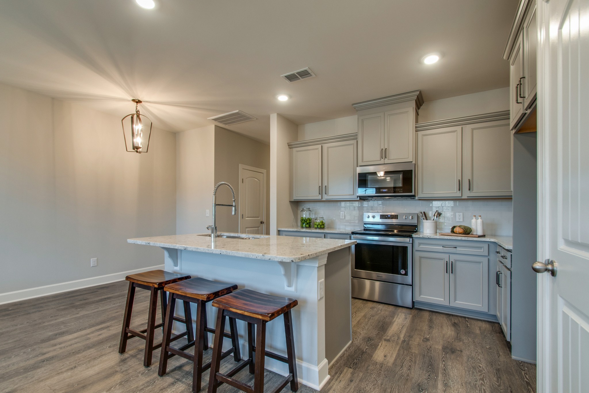 3309 Deerchase Circle Murfreesboro, TN 37129 - Photo 10 of 27 a kitchen with stainless steel appliances granite countertop a table chairs sink refrigerator and cabinets