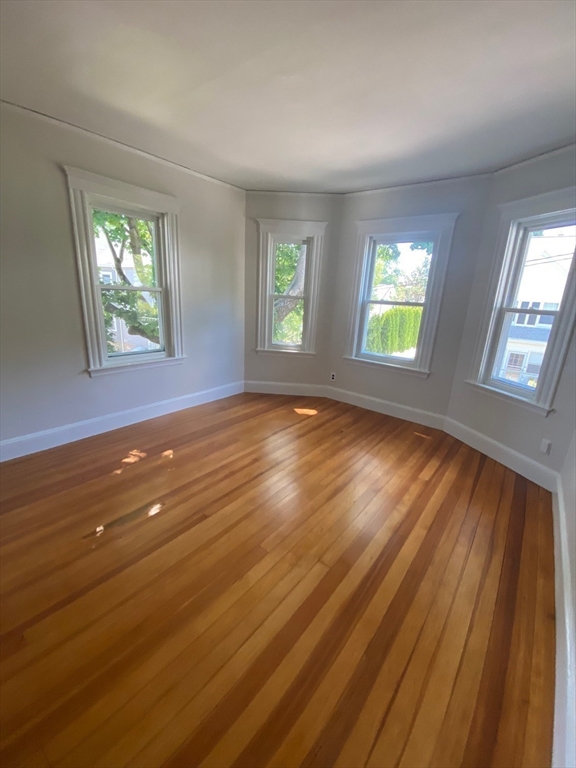14 Welton Road Boston, MA 02132 - Photo 24 of 31 a view of an empty room with wooden floor and a window