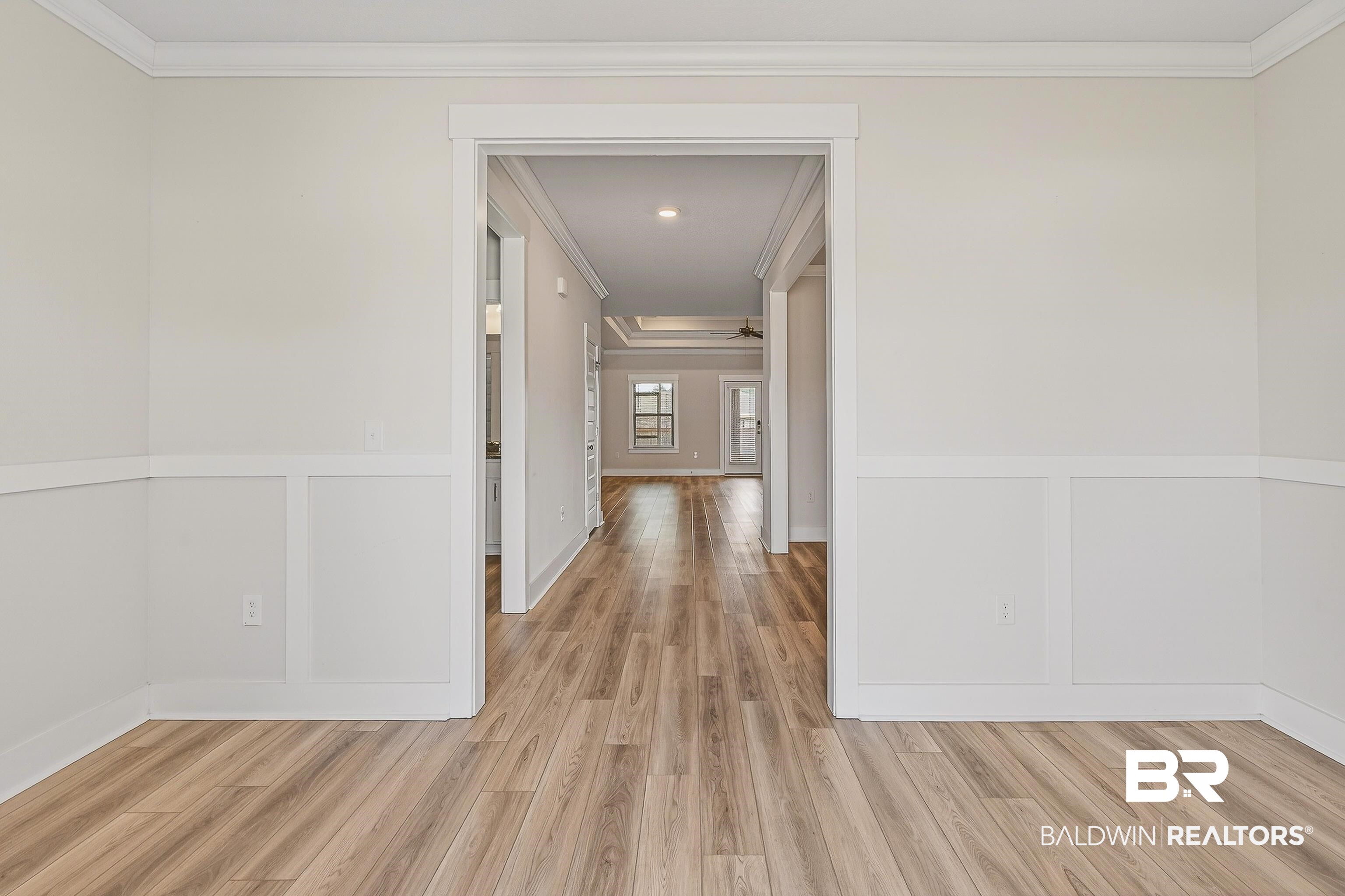 1728 Partridge Street Foley, AL 36535 - Photo 5 of 37 Corridor with ornamental molding, light wood-style flooring, and wainscoting