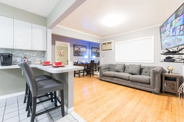 a living room with furniture and a kitchen view