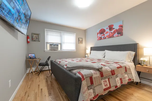 a bedroom with a bed and a table