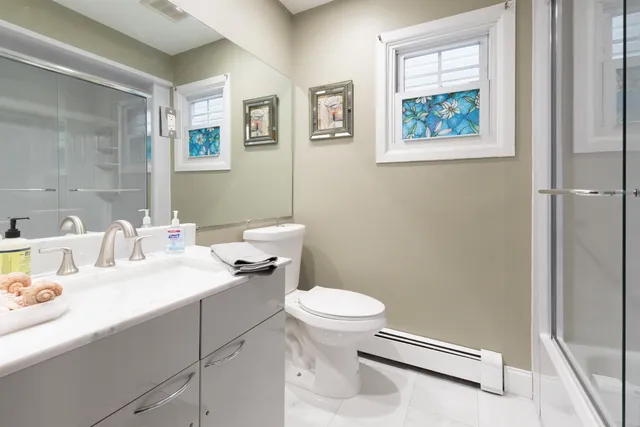 a bathroom with a toilet sink and mirror
