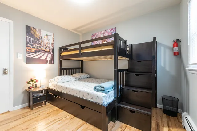 a bedroom with a bed and a dresser in it