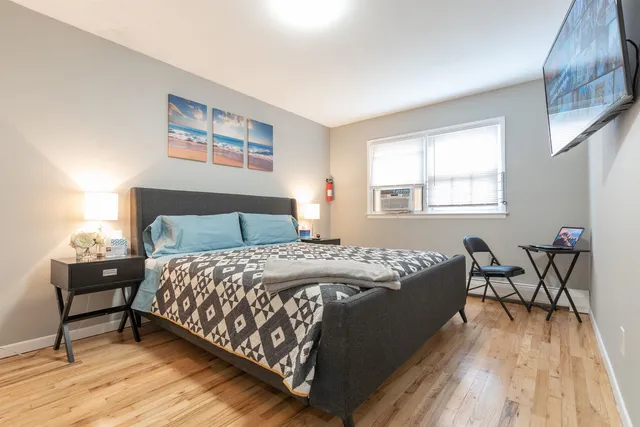 a bed sitting in a bedroom next to a window