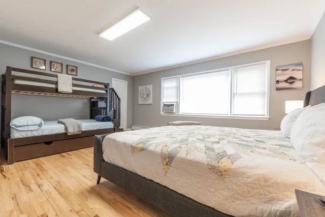 a bedroom with a bed and a window