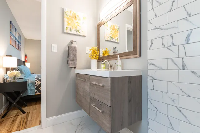 a bathroom with a sink vanity and a mirror