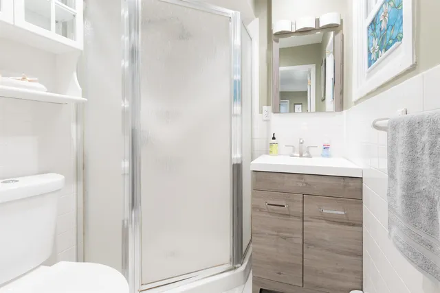 a bathroom with a sink a toilet and shower