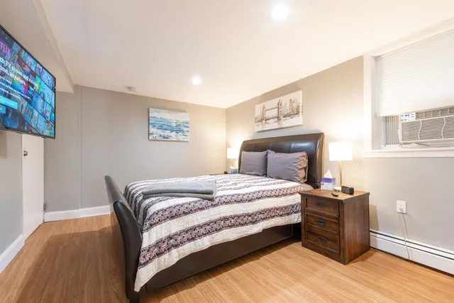 a bedroom with a bed and a chair