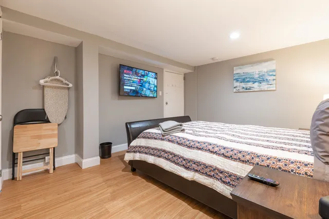 a bedroom with a large bed and a window