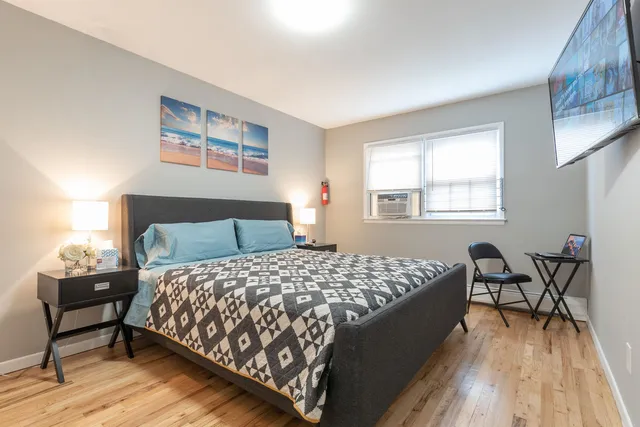 a bedroom with a bed and table chair