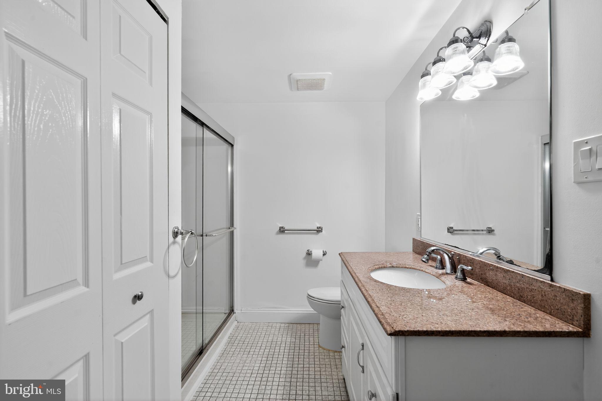 17 Haddonfield Cmns Haddonfield, NJ 08033 - Photo 12 of 37 a bathroom with a granite countertop sink a toilet and a mirror