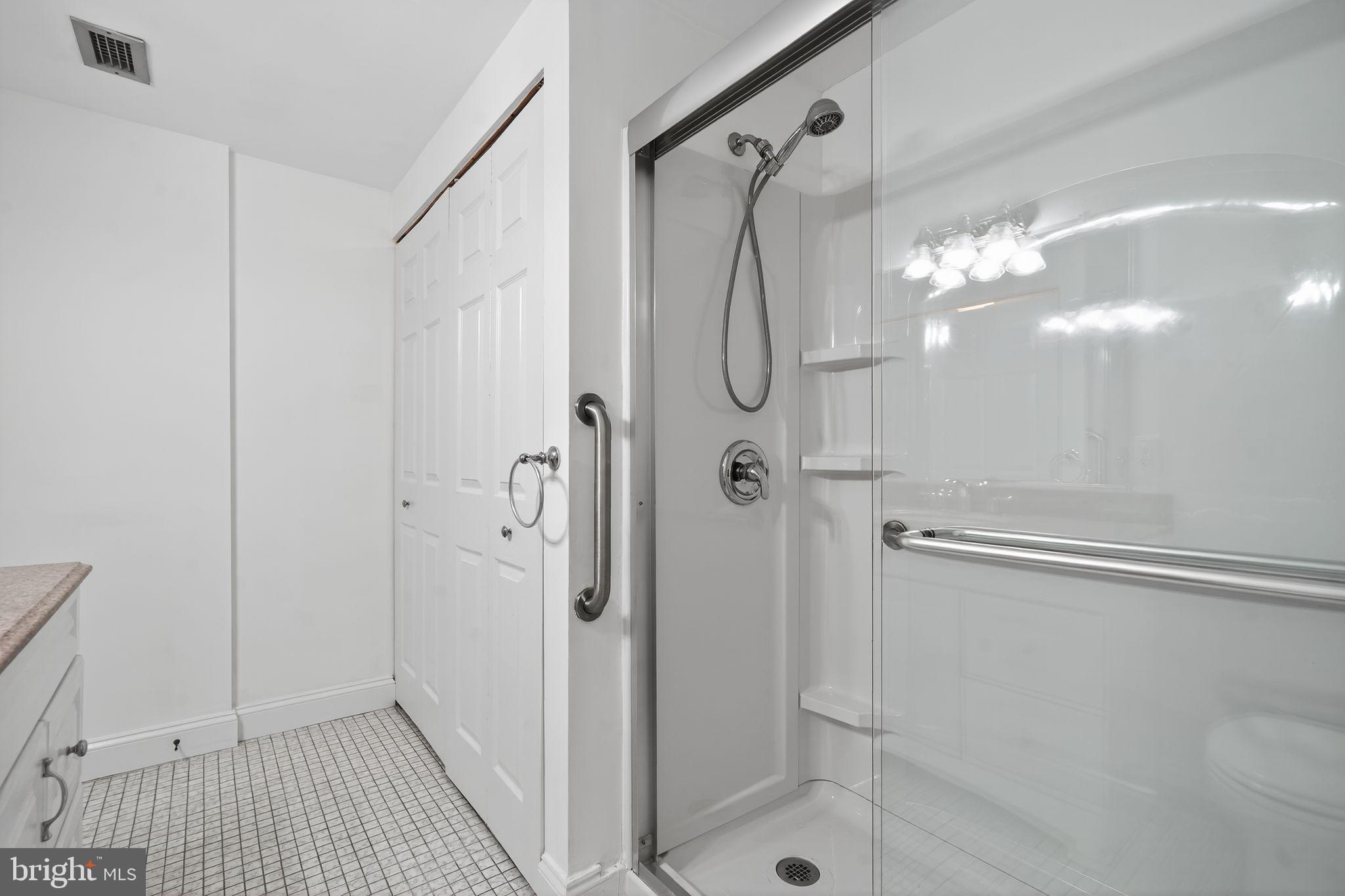 17 Haddonfield Cmns Haddonfield, NJ 08033 - Photo 13 of 37 a bathroom with a glass shower door and a sink