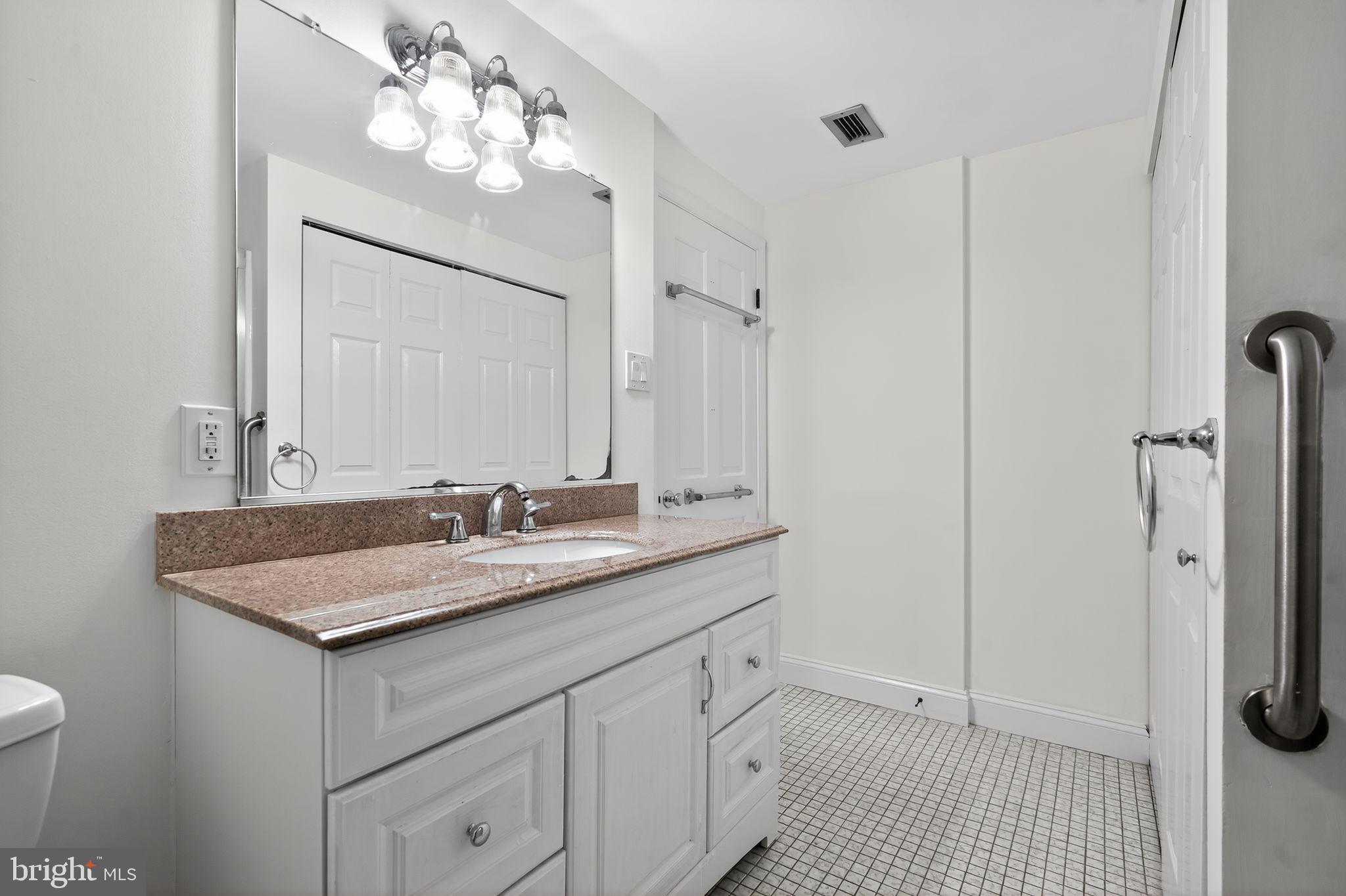 17 Haddonfield Cmns Haddonfield, NJ 08033 - Photo 14 of 37 a bathroom with a sink a light fixture and a mirror