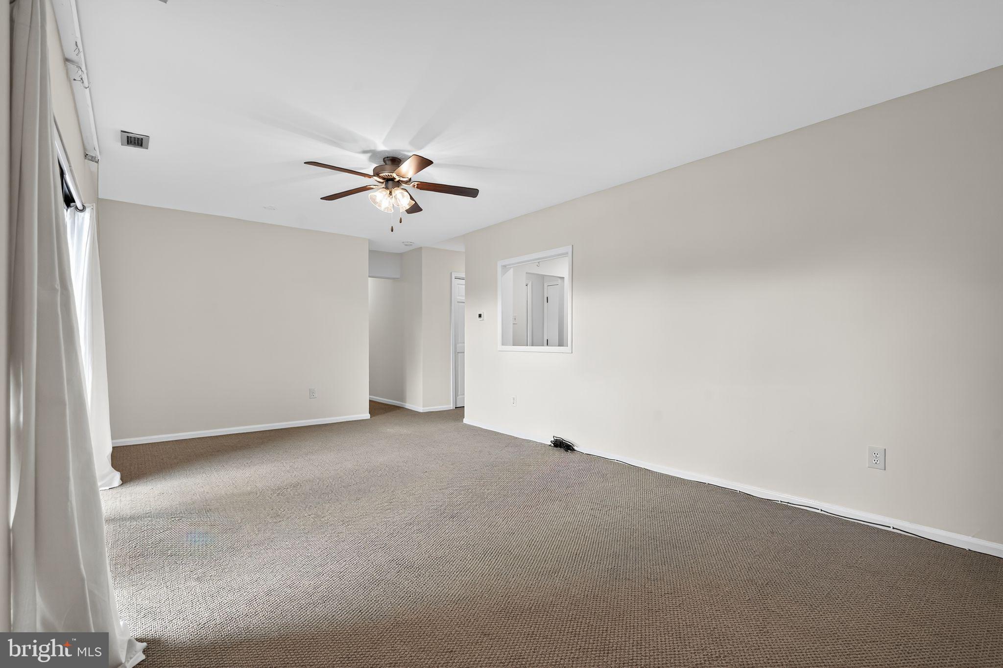 17 Haddonfield Cmns Haddonfield, NJ 08033 - Photo 15 of 37 an empty room with chandelier fan and windows