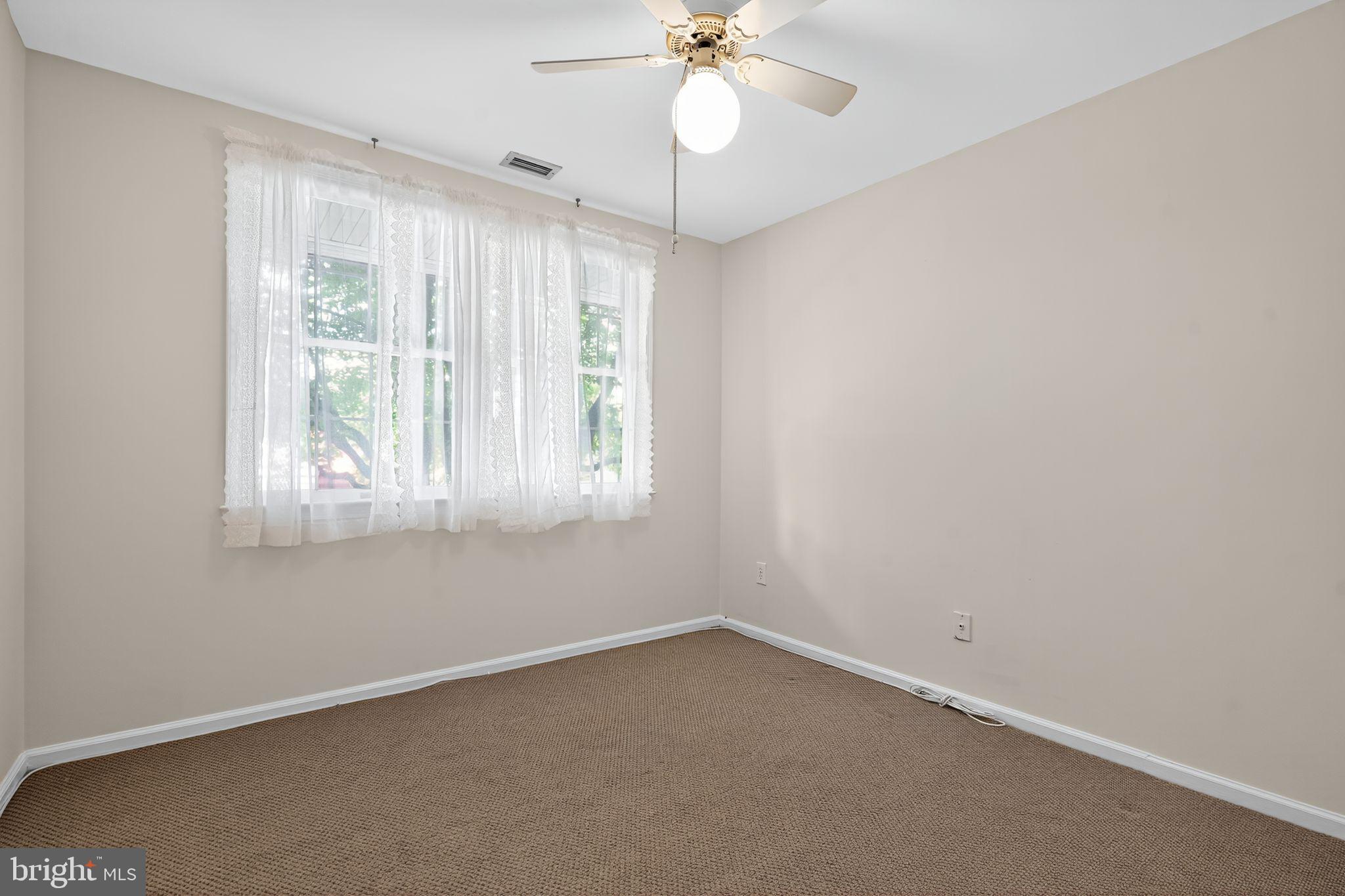 17 Haddonfield Cmns Haddonfield, NJ 08033 - Photo 16 of 37 an empty room with a window and a fan