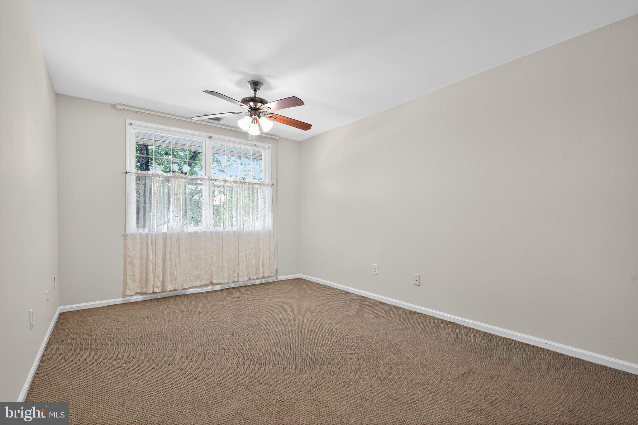 17 Haddonfield Cmns Haddonfield, NJ 08033 - Photo 17 of 37 an empty room with a window and a ceiling fan