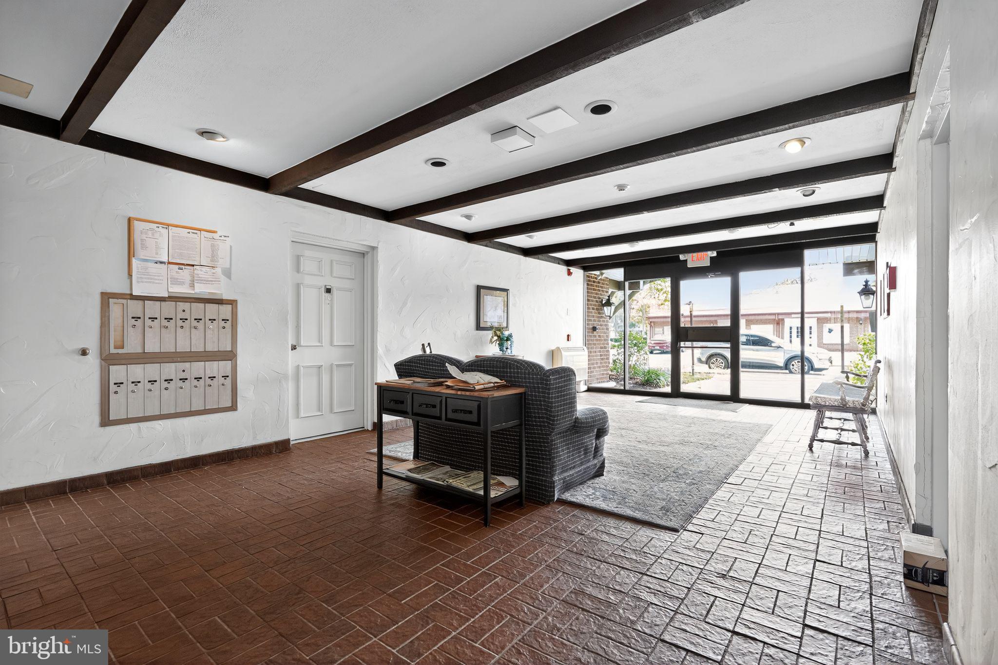 17 Haddonfield Cmns Haddonfield, NJ 08033 - Photo 6 of 37 a living room with furniture and large windows