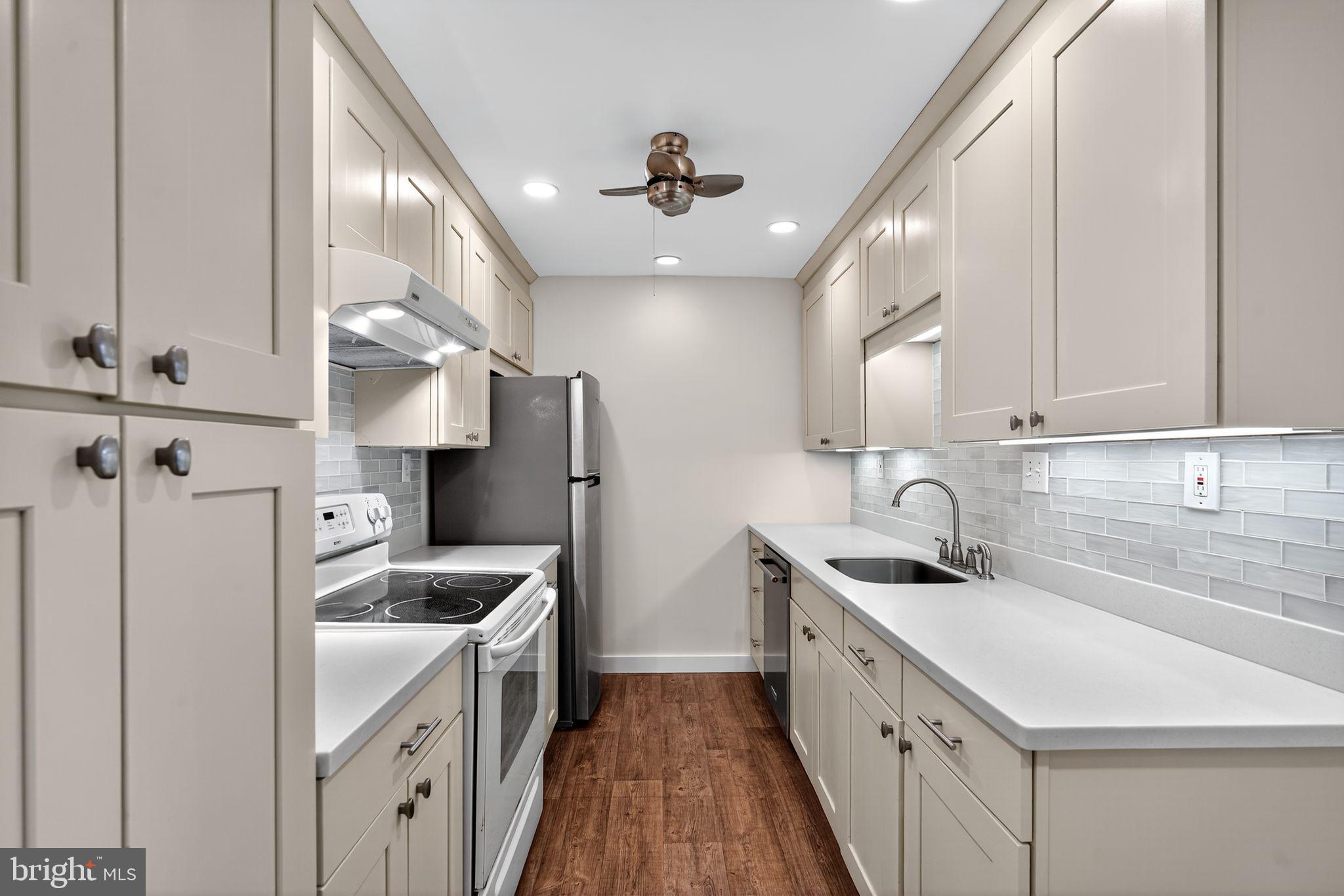 17 Haddonfield Cmns Haddonfield, NJ 08033 - Photo 8 of 37 a kitchen with stainless steel appliances a sink stove and cabinets