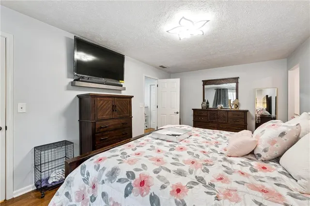 a bedroom with a bed and a flat screen tv