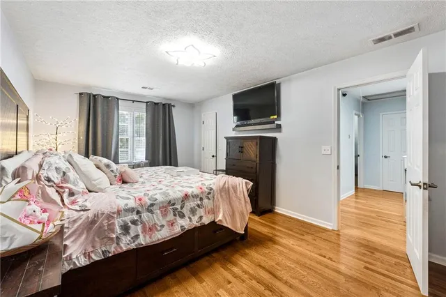 a bedroom with a bed and a television