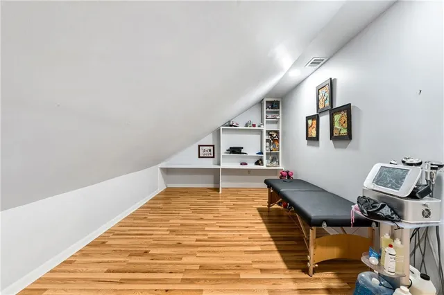 a view of a room with wooden floor and windows