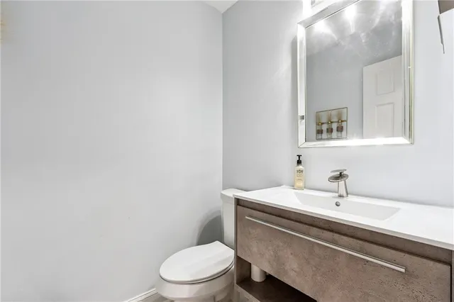 a bathroom with a sink a toilet and mirror