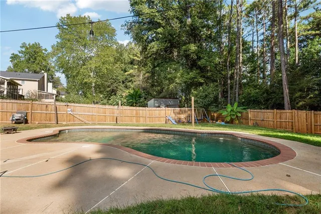 a view of a swimming pool with a yard