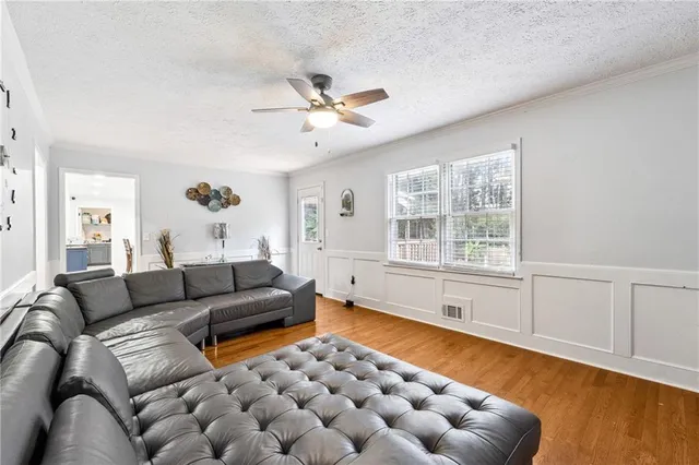 a living room with furniture and wooden floor