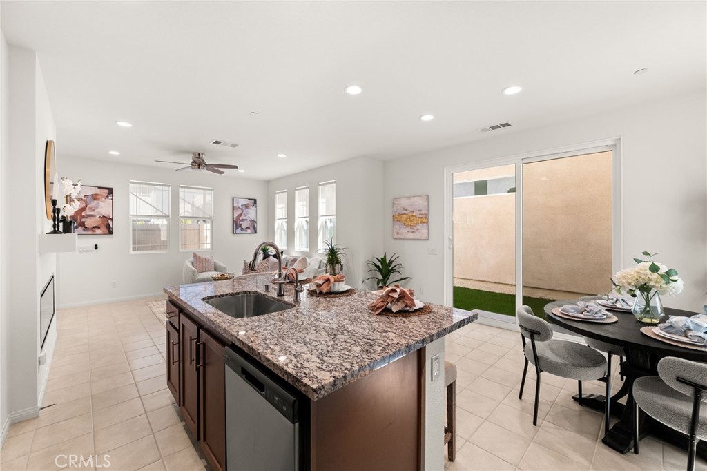 32461 Brunello Way Temecula, CA 92591 - Photo 16 of 46 a kitchen with granite countertop kitchen island stainless steel appliances a sink and living room