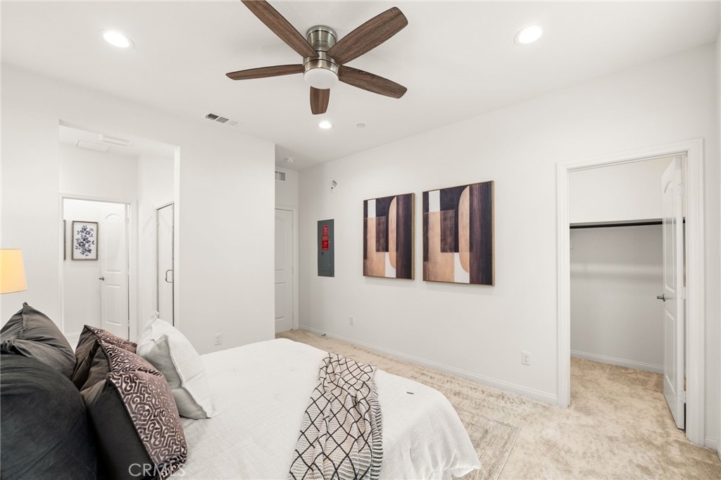 32461 Brunello Way Temecula, CA 92591 - Photo 19 of 46 a bedroom with a large bed and a chandelier