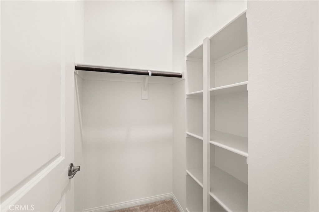 32461 Brunello Way Temecula, CA 92591 - Photo 26 of 46 a view of walk in closet with empty racks
