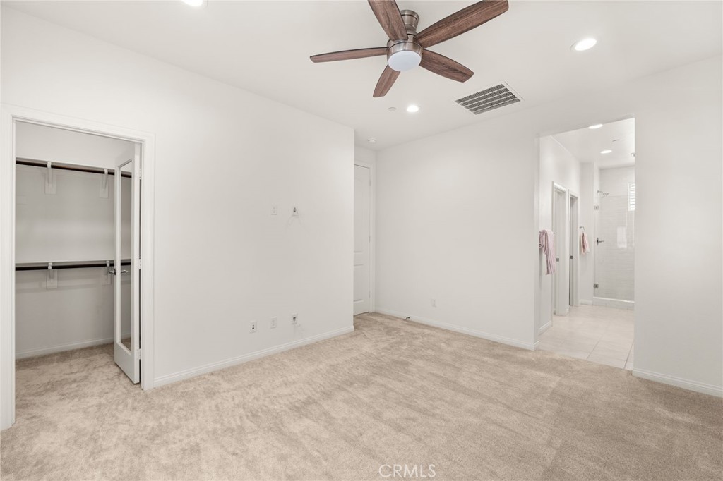 32461 Brunello Way Temecula, CA 92591 - Photo 28 of 46 an empty room with closet and a ceiling fan