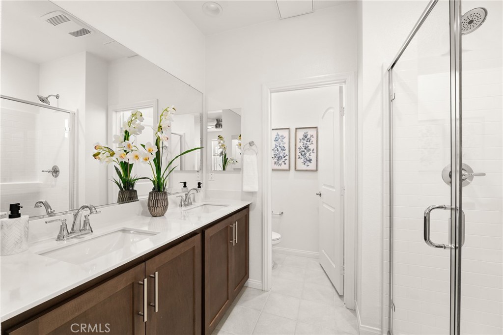 32461 Brunello Way Temecula, CA 92591 - Photo 30 of 46 a bathroom with a granite countertop sink and a mirror