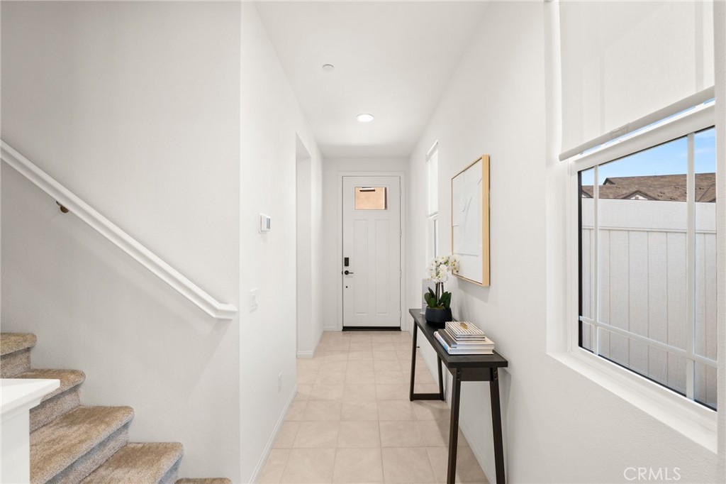 32461 Brunello Way Temecula, CA 92591 - Photo 7 of 46 a hallway with front door wooden floor and windows