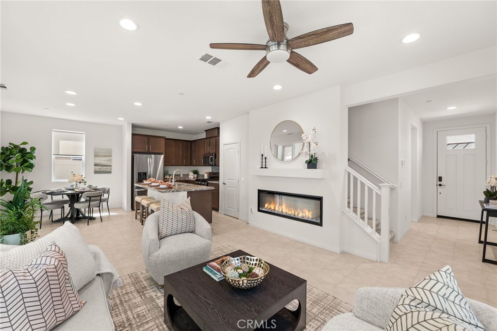 32461 Brunello Way Temecula, CA 92591 - Photo 10 of 46 a living room with furniture kitchen view and a wooden floor