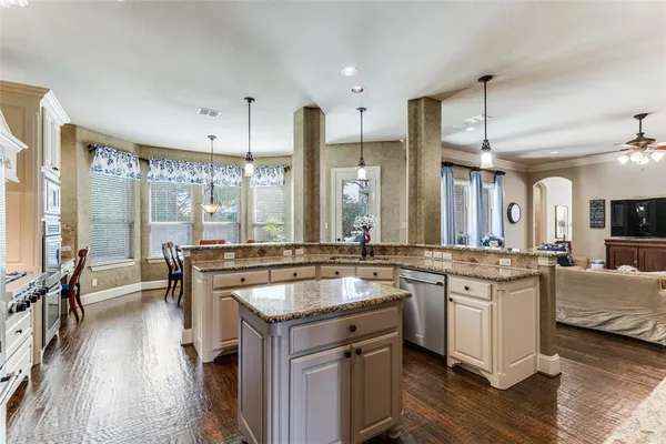 a kitchen with a sink stove and cabinets