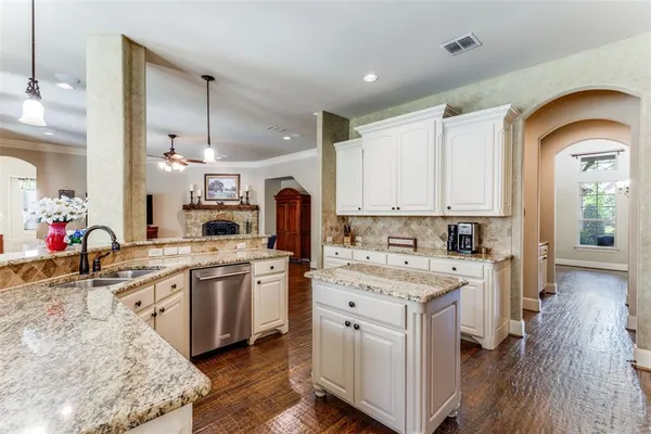 a kitchen with stainless steel appliances granite countertop a stove and a microwave