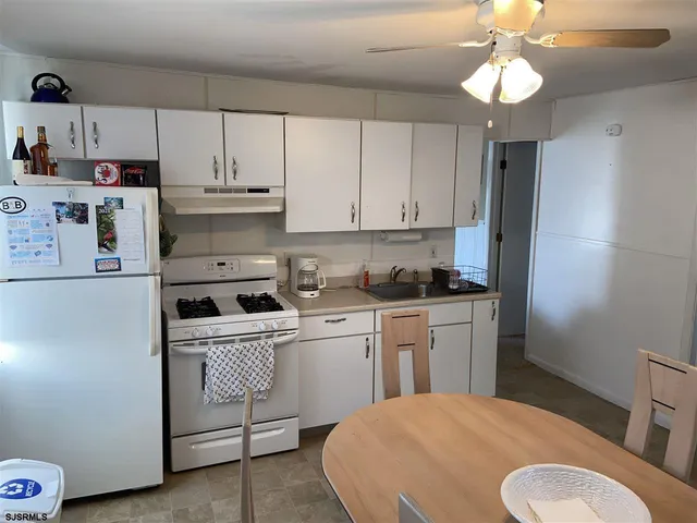 a kitchen with a white cabinets and white appliances