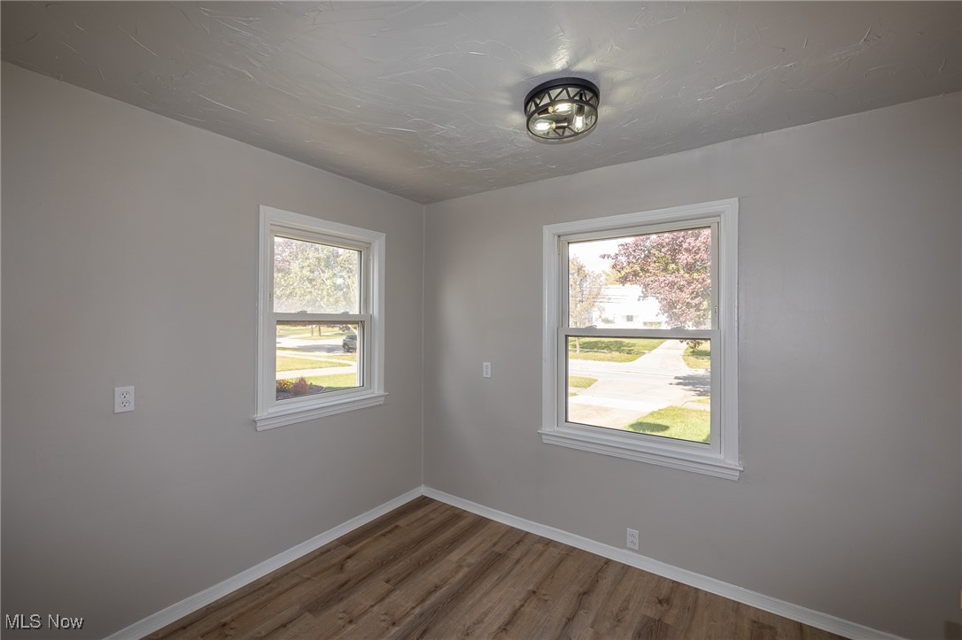 16002 Turney Road Maple Heights, OH 44137 - Photo 13 of 29 Empty room featuring wood finished floors and healthy amount of natural light