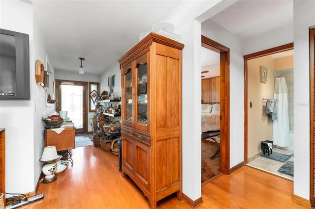 a living room with furniture a flat screen tv and a window