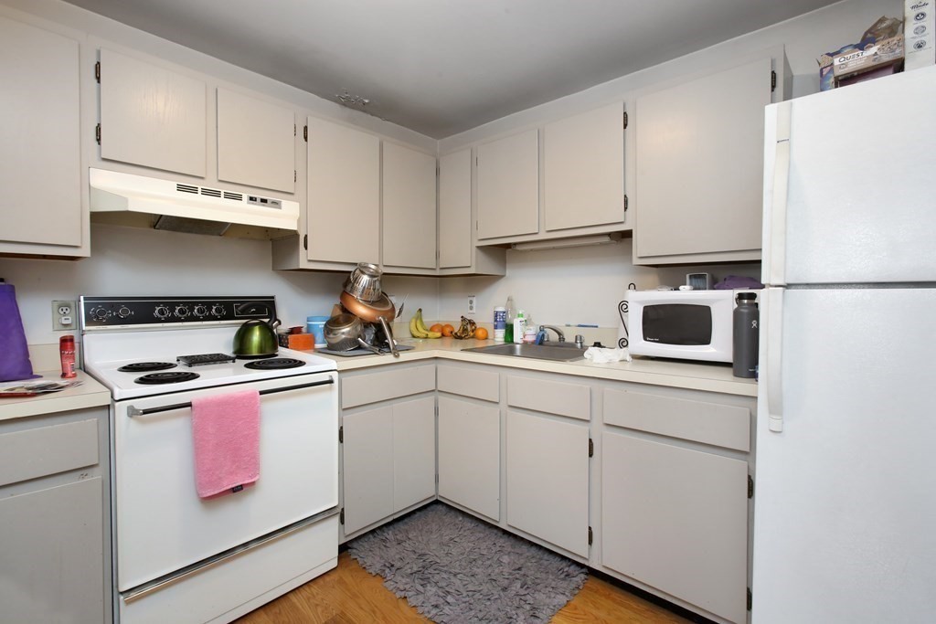 a kitchen with cabinets appliances and a sink