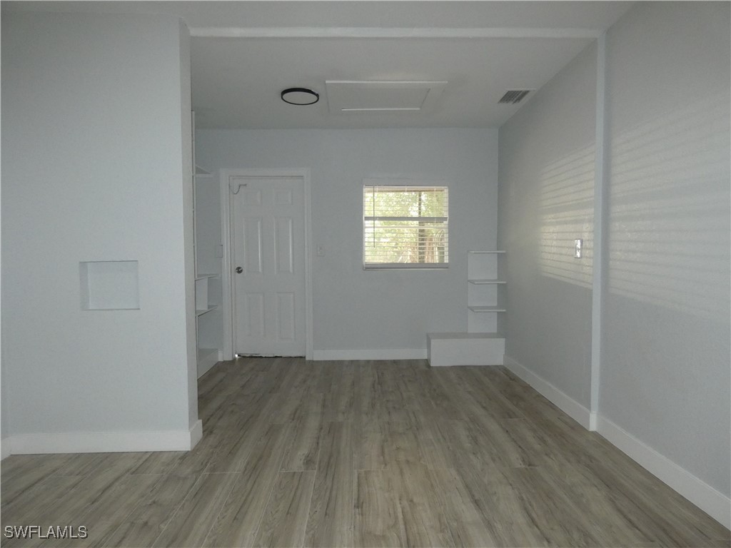 3817 Pearl Street Fort Myers, FL 33916 - Photo 16 of 21 an empty room with wooden floor and windows