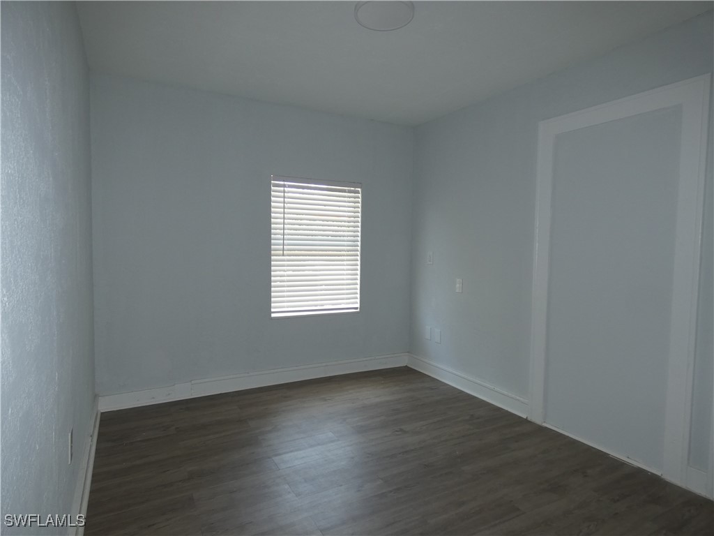 3817 Pearl Street Fort Myers, FL 33916 - Photo 8 of 21 an empty room with wooden floor and windows