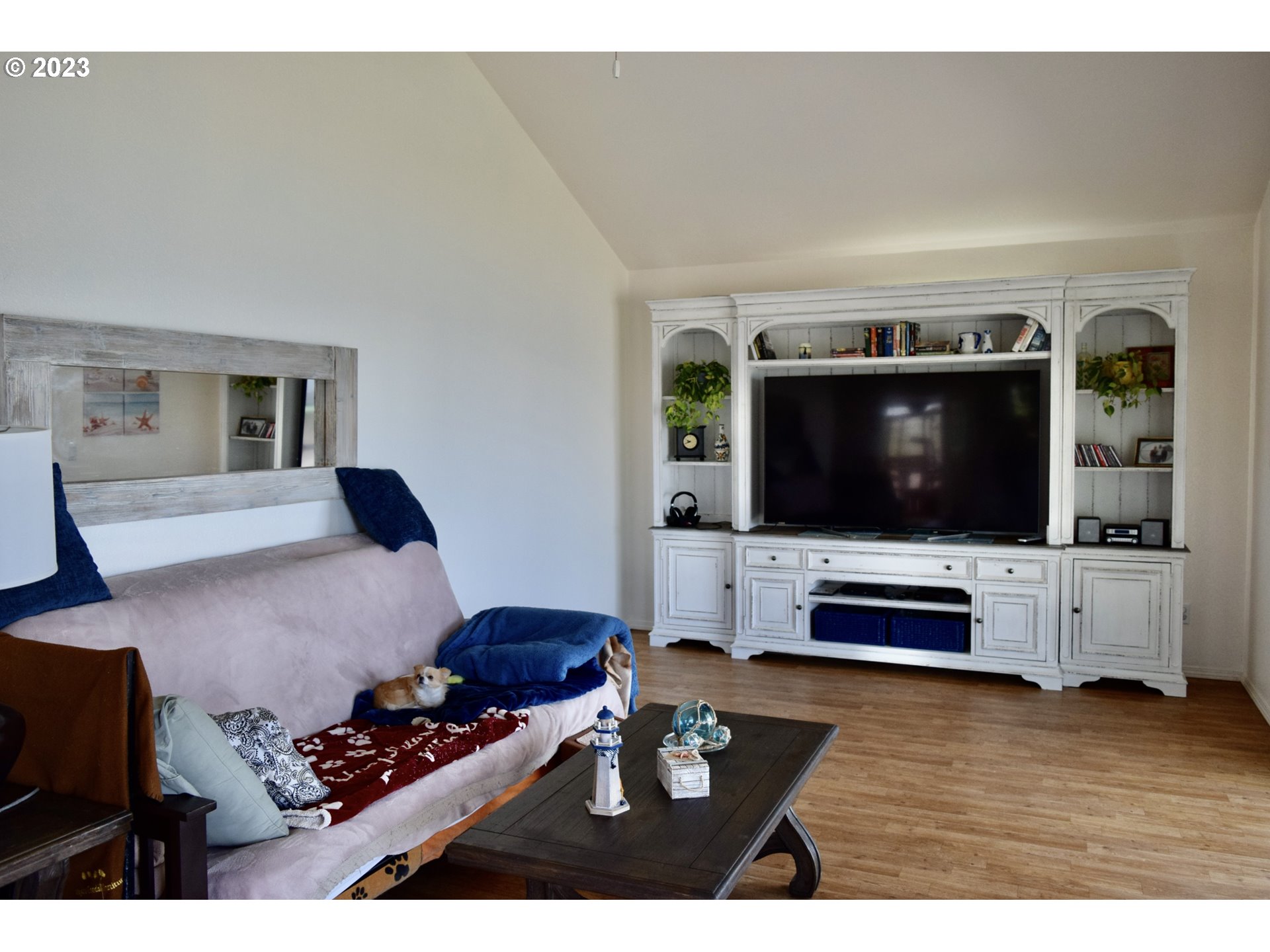 33074 Nesika Road Gold Beach, OR 97444 - Photo 11 of 40 a living room with furniture and a flat screen tv