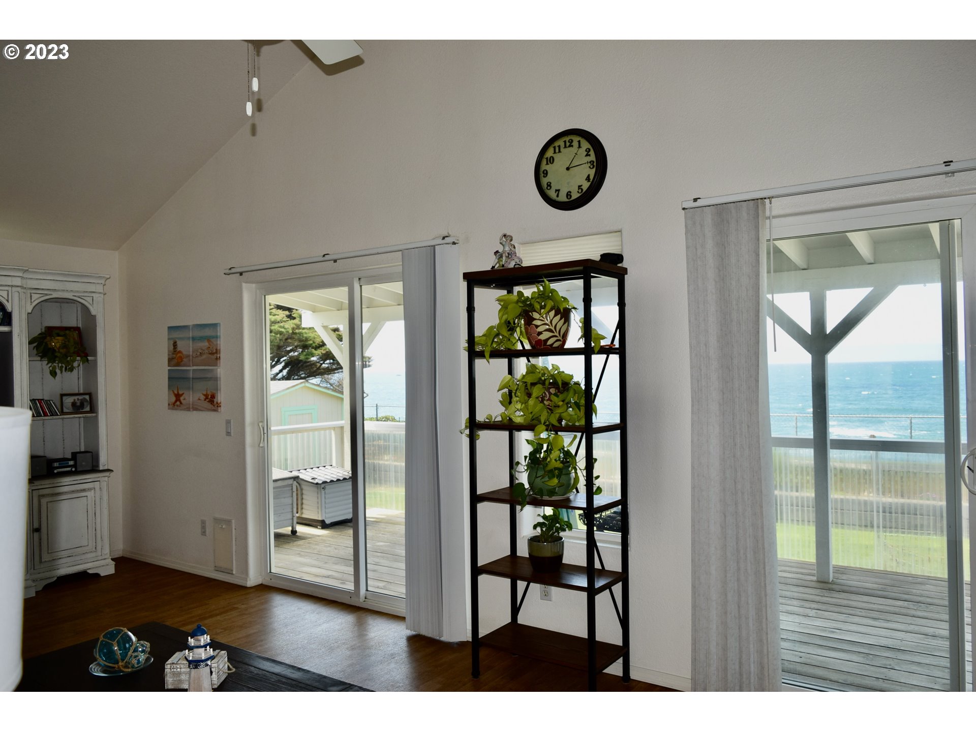 33074 Nesika Road Gold Beach, OR 97444 - Photo 14 of 40 a view of a hallway with wooden floor and a bookshelf