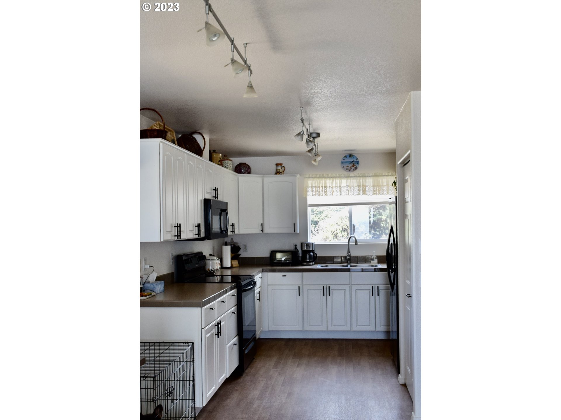 33074 Nesika Road Gold Beach, OR 97444 - Photo 15 of 40 a kitchen with granite countertop a sink and cabinets
