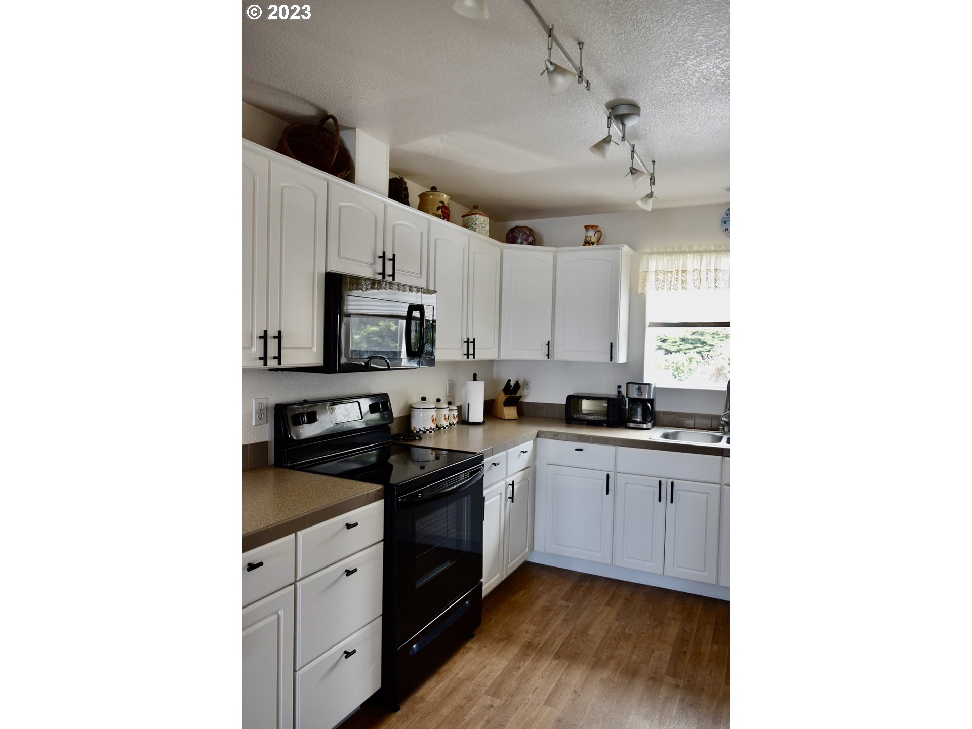 33074 Nesika Road Gold Beach, OR 97444 - Photo 17 of 40 a kitchen with granite countertop a sink stainless steel appliances and cabinets