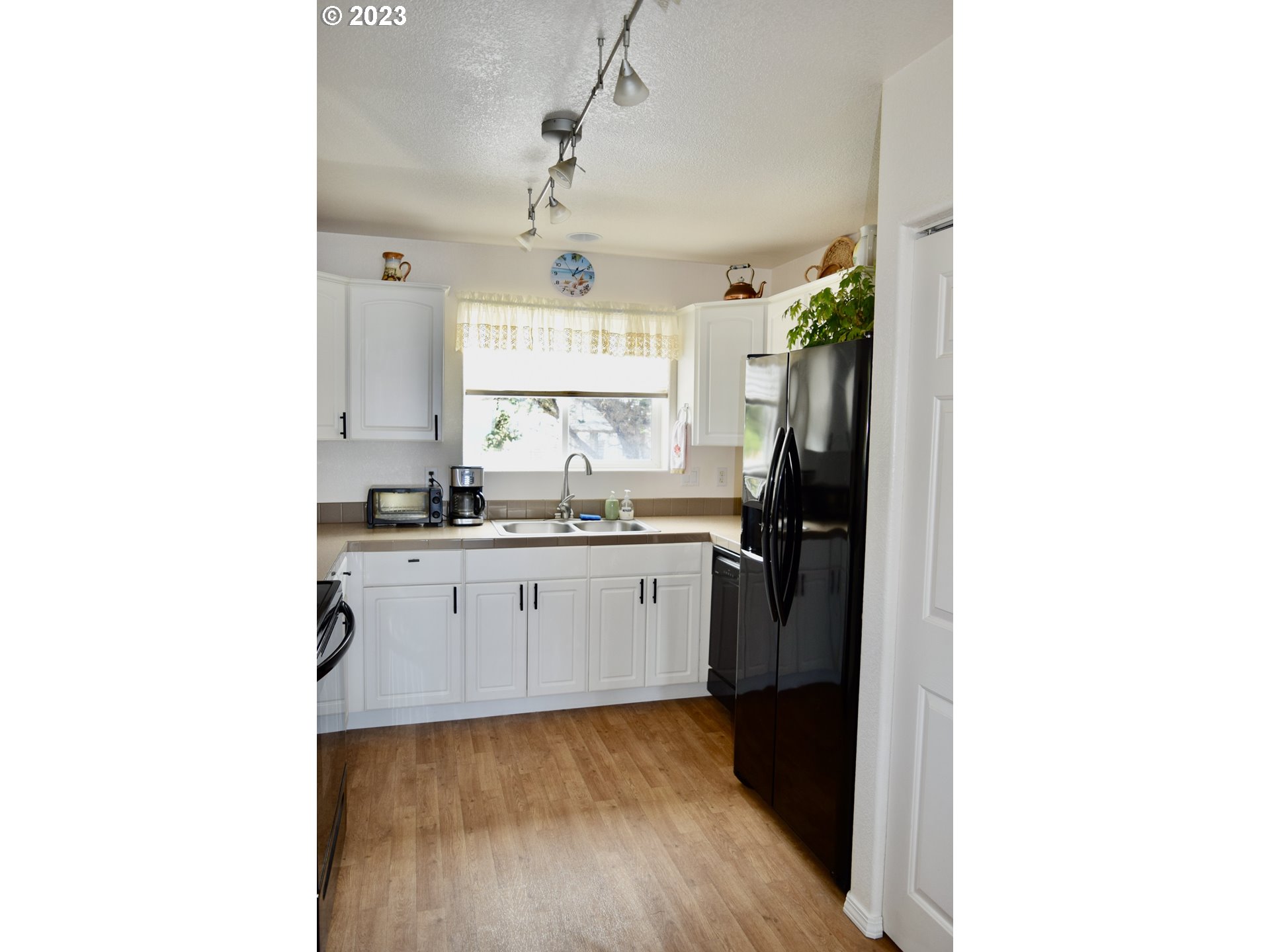 33074 Nesika Road Gold Beach, OR 97444 - Photo 19 of 40 a kitchen with a refrigerator and a sink