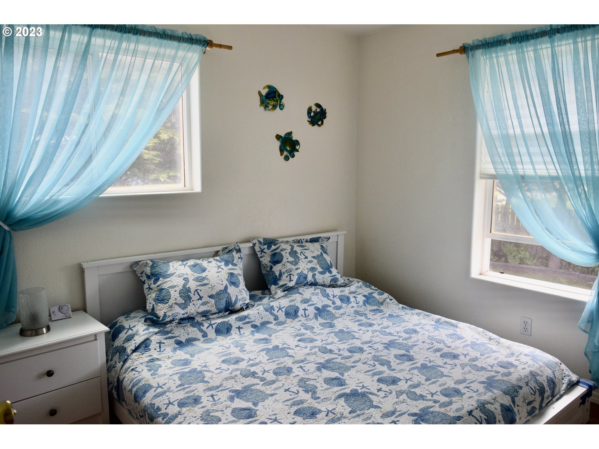 33074 Nesika Road Gold Beach, OR 97444 - Photo 20 of 40 a bedroom with a bed and window